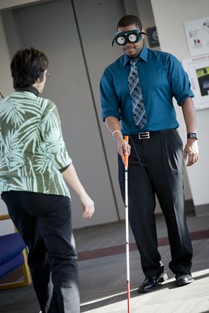 man walking with white cane