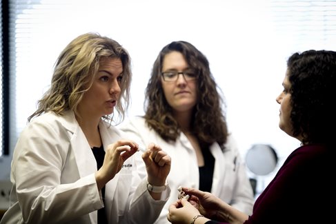 Dayle Paustian talking to a patient in a PEI exam room