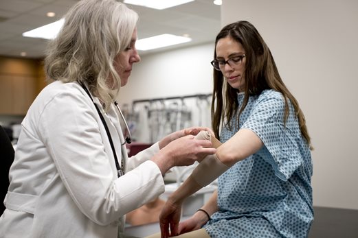 PA wrapping a patient's arm