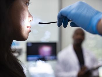 patient with endoscopic camera and light pointed at her face