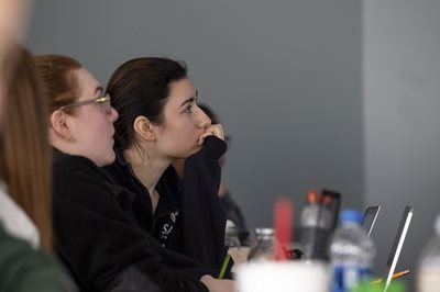 Student with her head in her hand in a classroom