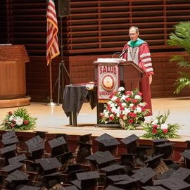 dr. mittelman at podium at commencement