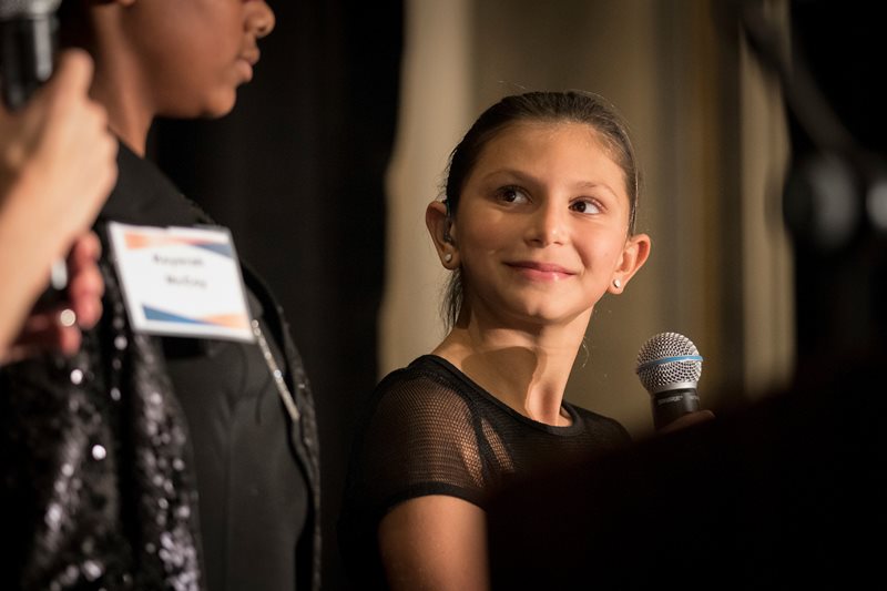 LOFK student holding a microphone