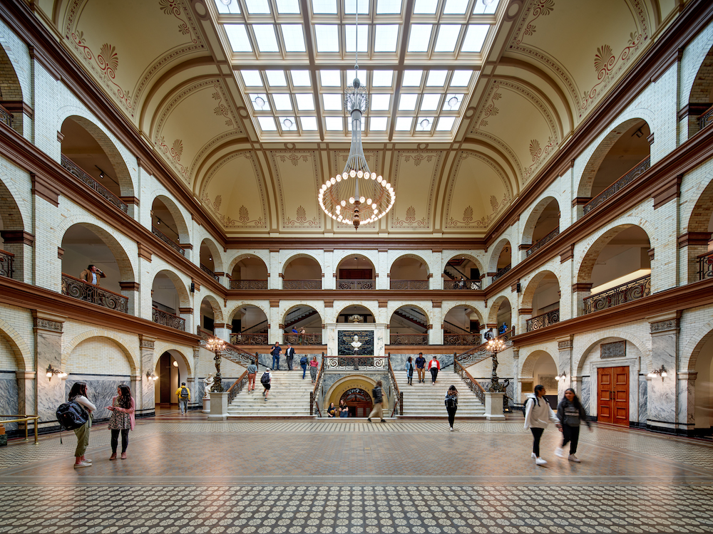 Students walking around inside a Drexel campus building