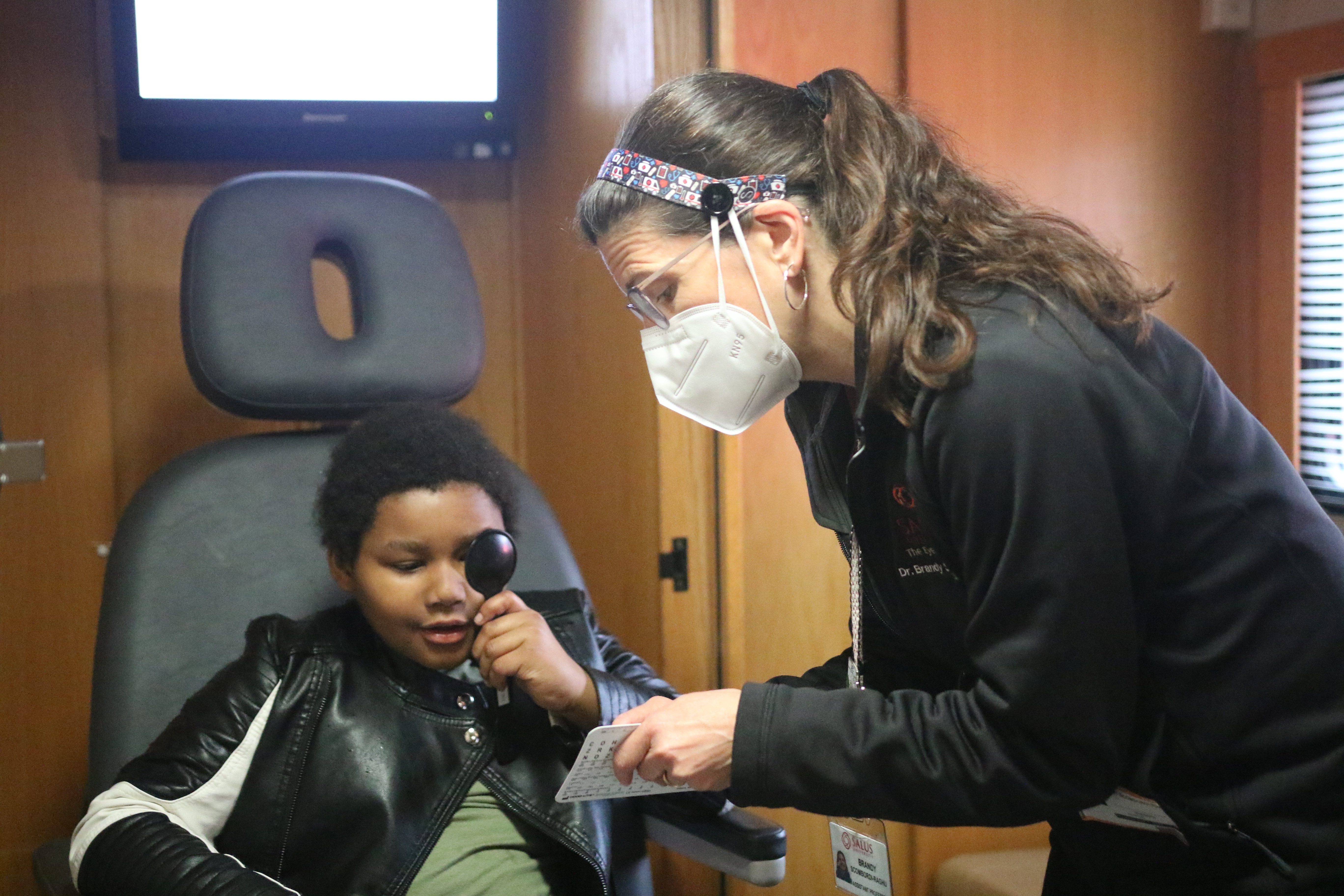 Dr. Scombordi-Raghu providing an eye exam to a pediatric patient