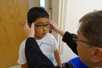 Student being fitted for glasses