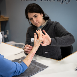 Alta Fried performing a hand exam