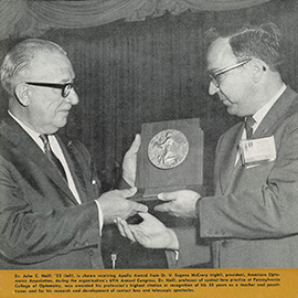 Dr. John C. Neill, ’22 (left) is shown receiving the Apollo Award from Dr. V. Eugene McCrary (right)