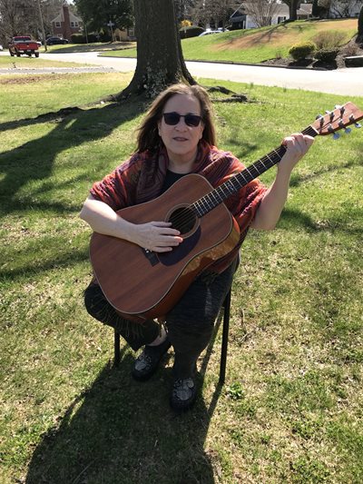 Amy Lustig playing guitar