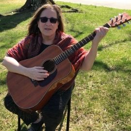 Amy Lustig playing guitar