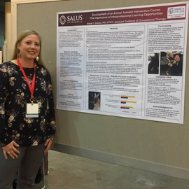 Anna Grasso standing in from of a poster of her research, smiling