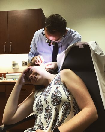 Anthony Oliveti working with a patient