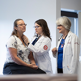 Physician Assistant student and faculty with a patient