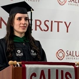 Ashley Senss speaking at a podium