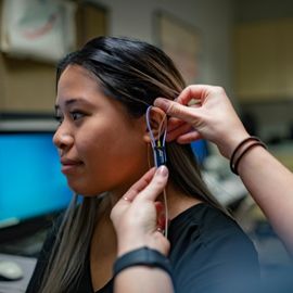 Female patient being fitted for a hearing aid