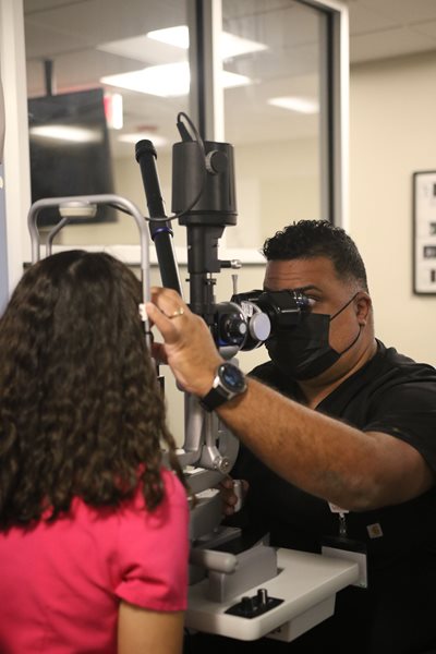 Antonio Martinez Barrera giving an eye exam