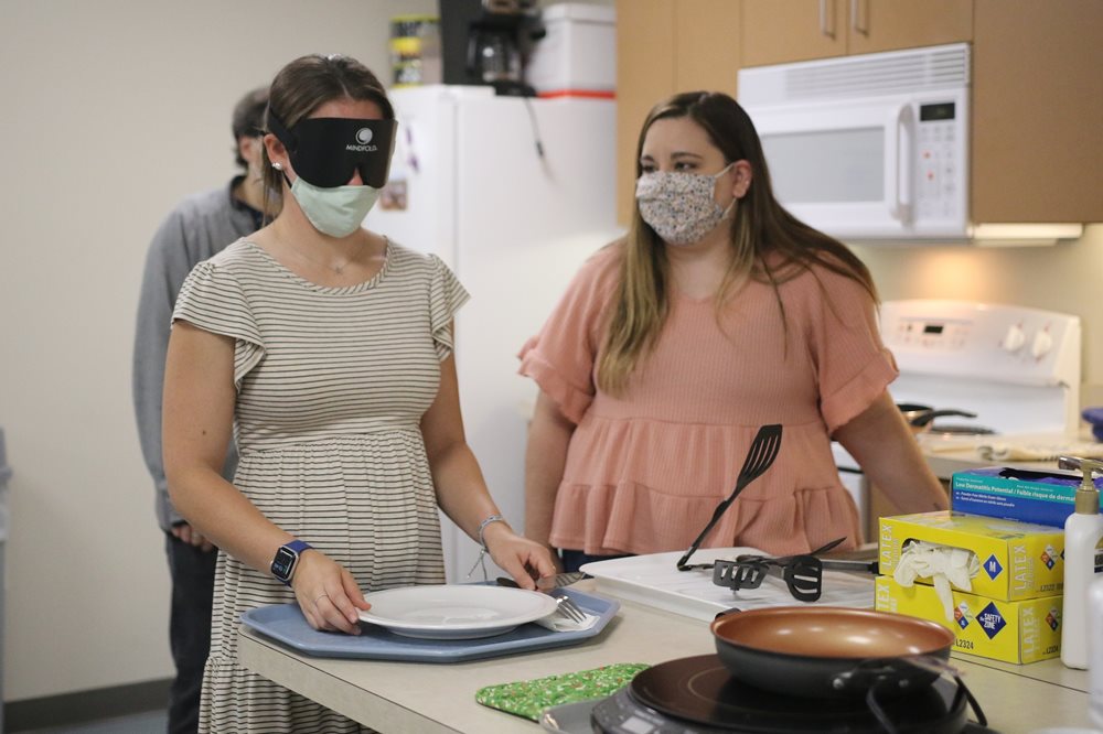 BLVS students practicing tasks while being blindfolded in the CHER lab