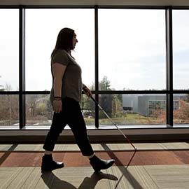 Visually impaired person with long white cane