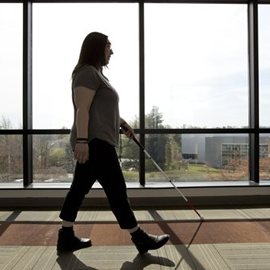 woman walking with white cane