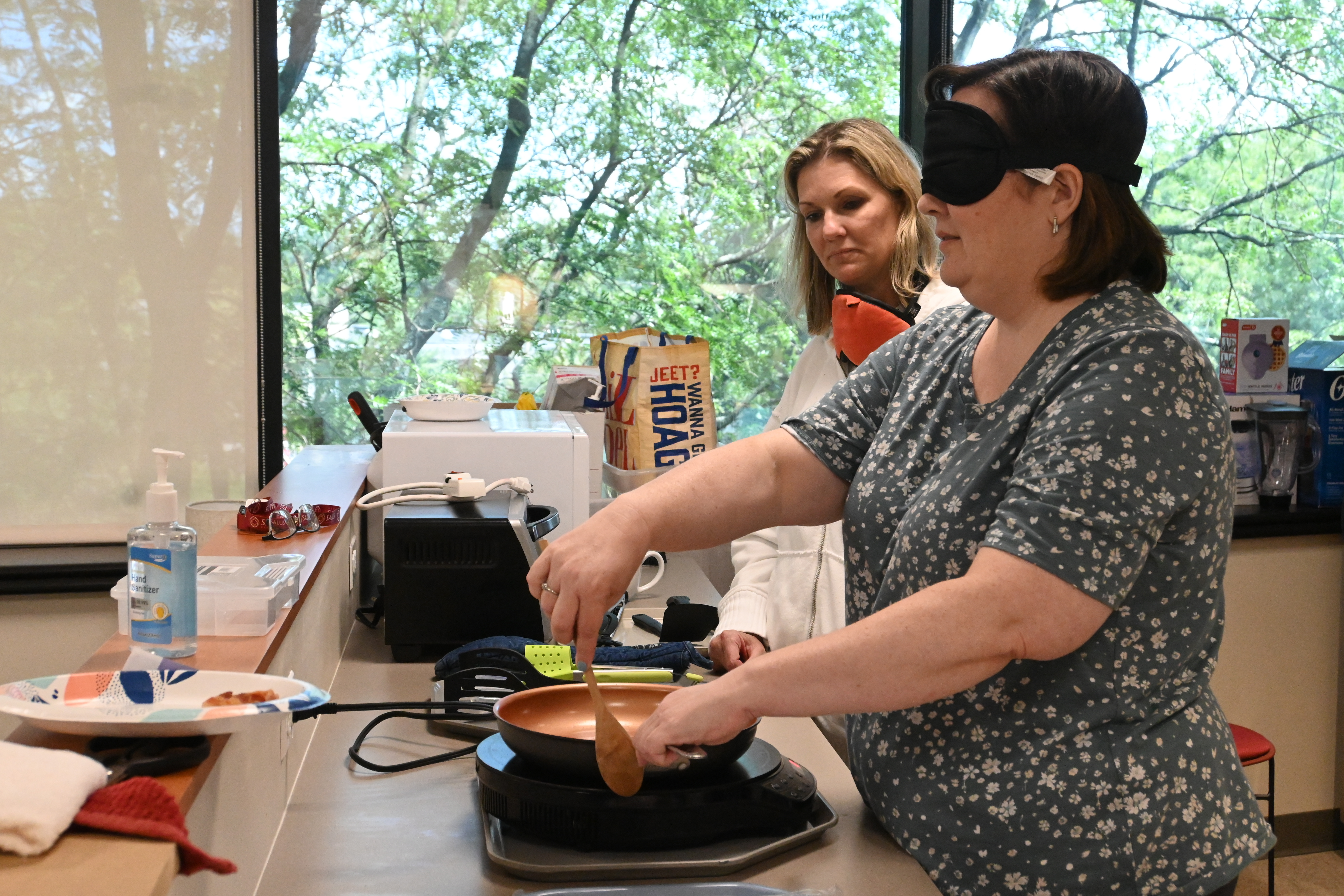 Person using a pan with a blindfold