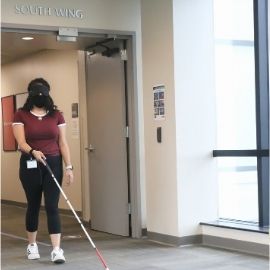 Student walking with a white cane