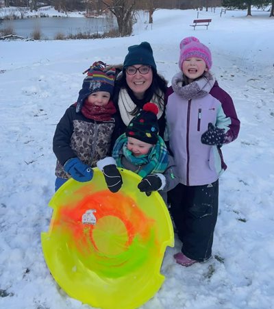 Caitlyn Foy with her three kids sledding