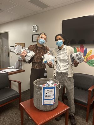 SLP students holding their donations for the sock drive