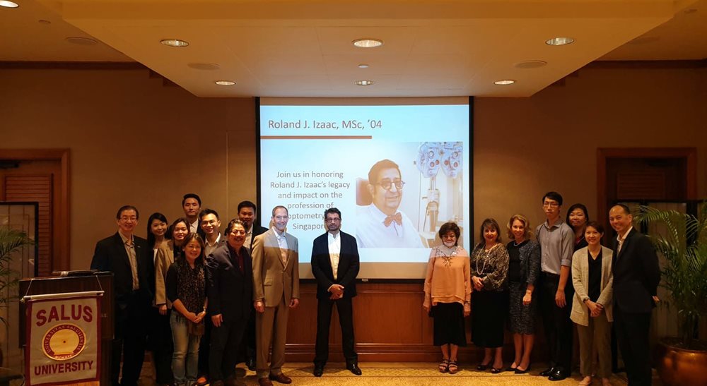 Group photo in front of a presentation 