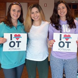 OT students holding "i love OT" signs