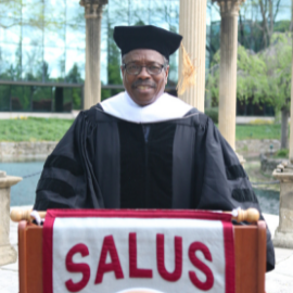 Dean Horne wearing graduation regalia