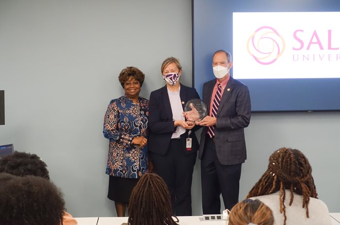 Dr. Paula Harmon Boone presenting the NOA School of the Year award to University officials during DEI Speaks event