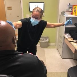 Dr. Erin Draper working with a patient