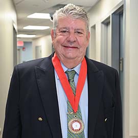 Headshot of Dr. John Fitzgerald wearing medal