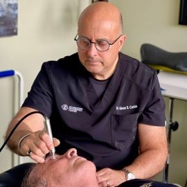 Dr. Glenn Corbin examining a patient