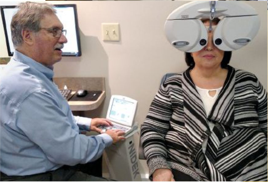 Harvey Hanlen providing an eye exam to a patient