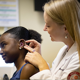 Pediatric patient being fitted for a hearing aid