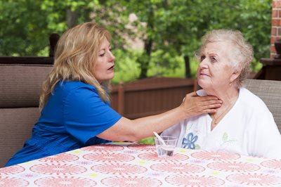 nurse touching patient's throat