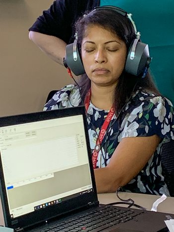 Jenny Rajan wearing headphones