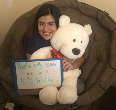 Kelly Garcia hosting a stuffed animal bear