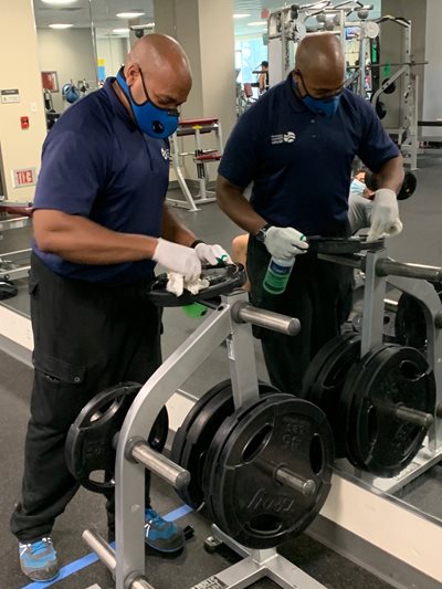 Landon Godsey III cleaning gym equipment