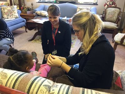 Dr. Lindsay Bondurant and clinician working with a pediatric patient