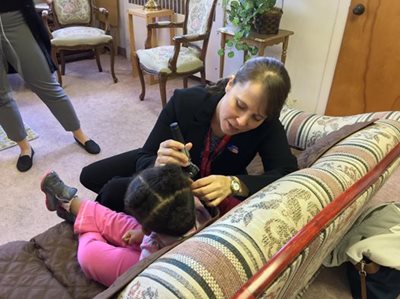 Dr. Lindsay Bondurant providing an ear exam