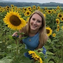 Katelyn Maffei in a sunflower field