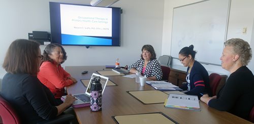 faculty sitting at a table