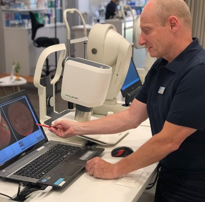 Michael Baertschi reviewing an eye exam