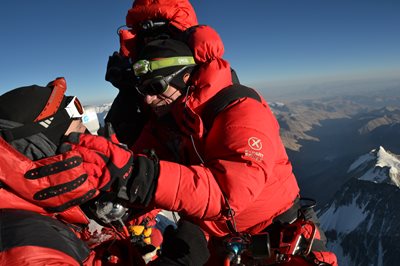 Michael Beartschi performing an eye exam on top of a mountain