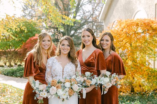 Megan, Kara, Jaclyn and Nicole together at a wedding as bride and bridesmaids