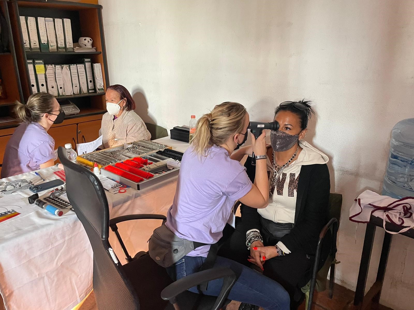 2 Salus students giving eye exams to 2 patients in Mexico