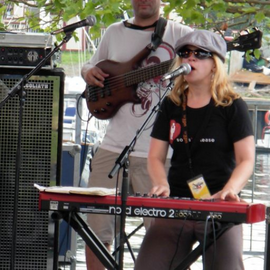 Nora Whittaker Jones playing an electric keyboard and singing