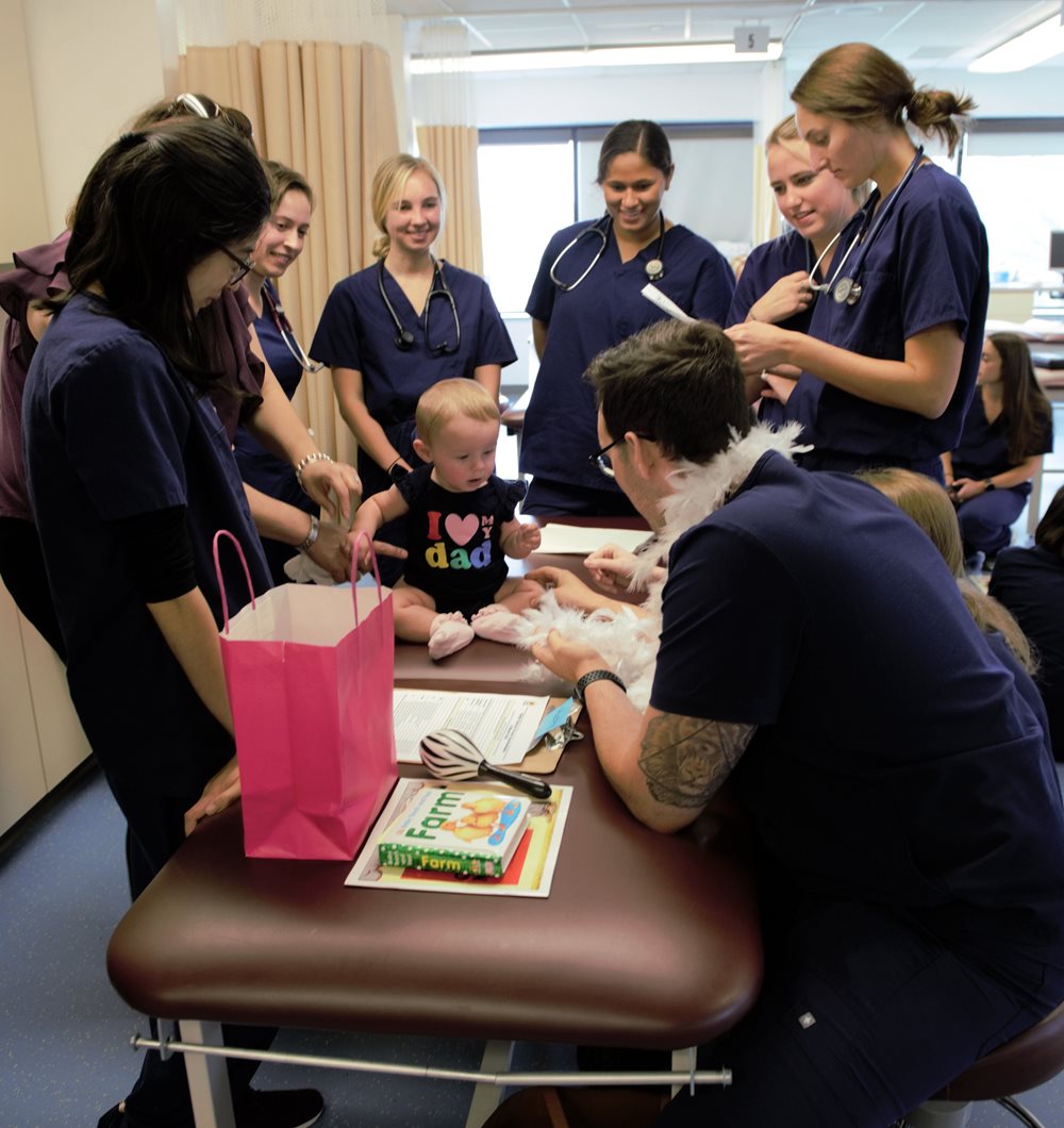 PA students in lab working with a pediatric patient